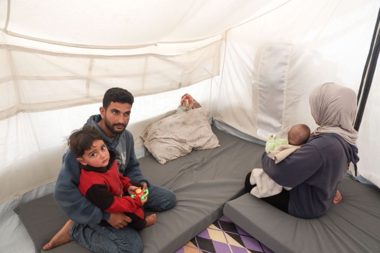 Gazans use drained phones as their only light source in darkness.